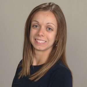 A closeup headshot of a woman with brown hair